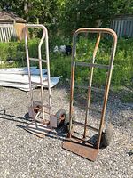 Front view of both hand trucks standing on gravel