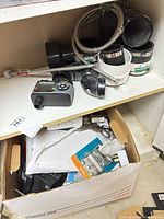 Shelf with timer, pipe couplings, box of hardware
