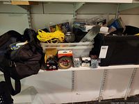 Overall view of three containers on shelf with visible rope and hardware