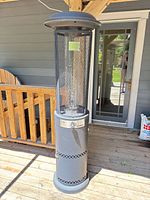 Full view of heater front, showing cylindrical body, mesh tower, domed top, control panel