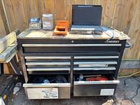 Front view of Husky tool chest with drawers open showing extension cord and tools