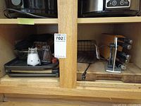 Cabinet shelf with cutting boards, knife block, cast iron griddle, cabinet caddy