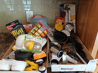 Overview of two boxes filled with assorted kitchen tools and gadgets