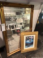 Front view of gold-tone mirror with framed mermaid print