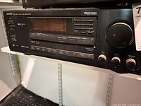 Front view of Onkyo receiver showing display, controls and volume knob
