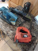 Overview of three corded power tools on countertop