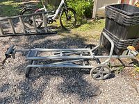 Side view of folded Ridgid miter saw utility vehicle with wheels and handle