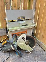 Concrete saw and table saw together for scale