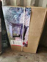 Sealed carton of Canvas Dashley outdoor serving cart leaning against wall