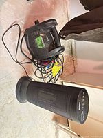 Both items on basement floor: Honeywell tower heater and Schumacher jump starter with cables