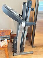 Side view showing folded Tempo 620T treadmill frame and motor housing