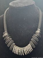 Full view of bib necklace on display bust