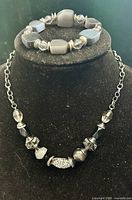 Necklace and bracelet on display bust
