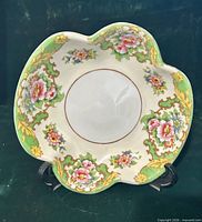 Top angled view of Noritake serving bowl showing floral pattern, green border, gold trim and rim shape