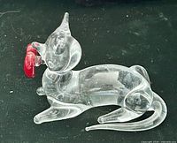 Side view clear glass cat holding red heart