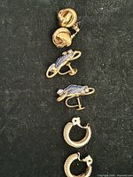All three earring pairs laid out vertically