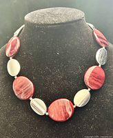 Necklace displayed on bust showing overall design and coloration