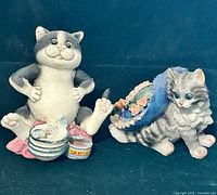 Both resin cat figurines side by side