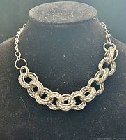 Full view of necklace on display bust showing overall design and length