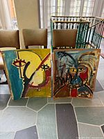 Both unframed acrylic paintings standing side-by-side showing full artwork surfaces and signature areas