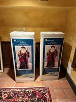 Two boxed Traditions Regal Santa figures front view