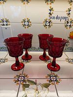 Four ruby Noritake goblets on tiled surface