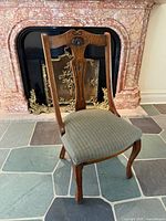 Front angled view of oak side chair in front of fireplace