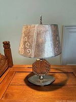 Front view of Crucet Art Deco lamp showing base, octagonal center, and paper shade