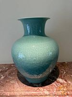 Front view of celadon porcelain vase showing overall shape and relief pattern