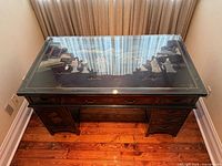 Top view showing glass surface with painted landscape beneath