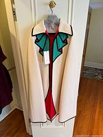 Front view of Gucci Trompe L'oeil wool cape with tag attached
