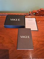 Notebook, box, and letter displayed on table