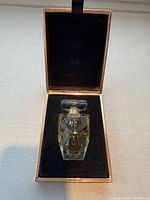 Bottle seated in box showing interior velvet insert