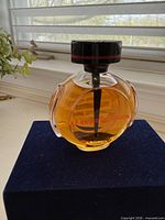 Front view of perfume bottle showing design and fill level
