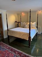 Full view of mahogany four-poster king bed frame showing posts, rails, and finish