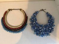 Both statement necklaces side by side