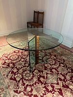 Full view of glass dining table on rug