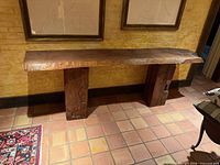 Full front view of console table showing live-edge top and both pedestal bases