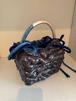 Front view of Edte Foam Bag Mini showing sculptural foam exterior, velvet lacing, wrapped handle