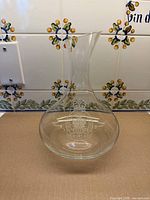 Front view showing full decanter and etched crest