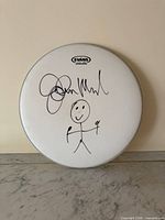 Front view of Evans drum head showing complete autograph and sketch