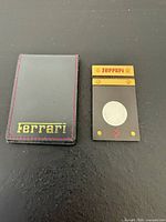 Cigar cutter beside branded leather sleeve front view