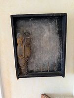 Front view of shadow box art showing textile fragment and backing
