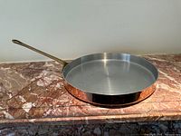 Angled view of entire pan on marble surface