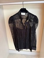 Front view of Gucci black lace shirt on hanger