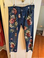 Full front view of hand-painted Bloom denim jeans