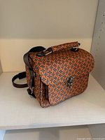 Front angled view showing overall design, pattern, strap and clasp