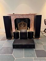 Front view of all six speakers arranged in front of fireplace