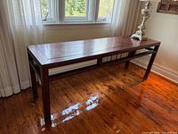 Full view of hardwood console table from front angle