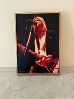 Framed photograph showing full image of Kurt Cobain in frame